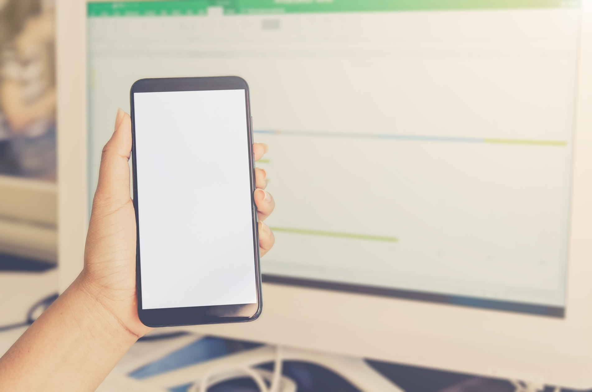 Hand Holding with Blank-Screened Smartphone with Computer